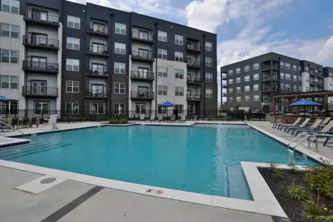 Graphite at Oakley pool and pool deck view of backside of apartments