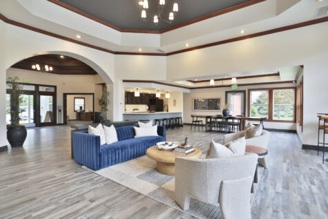 Newly updated clubhouse at Wellington Place Apartments featuring modern furnishings, a kitchenette, and stylish decor designed for relaxing or socializing.
