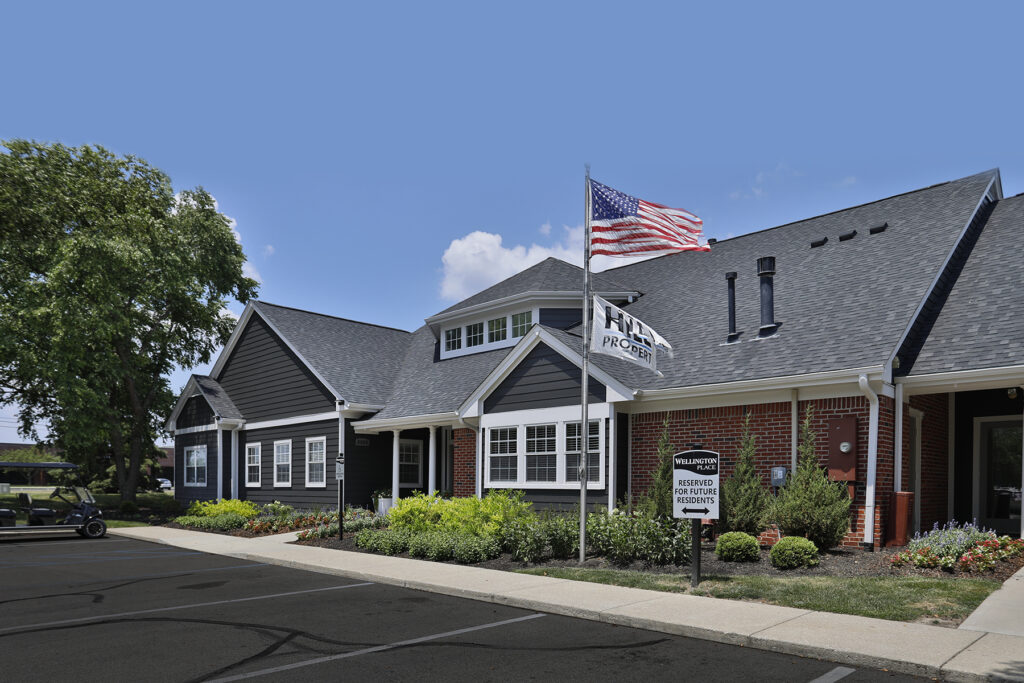 Clubhouse at Wellington Place Apartments featuring modern furnishings, a kitchenette, and stylish finishes, ideal for social gatherings and resident events.