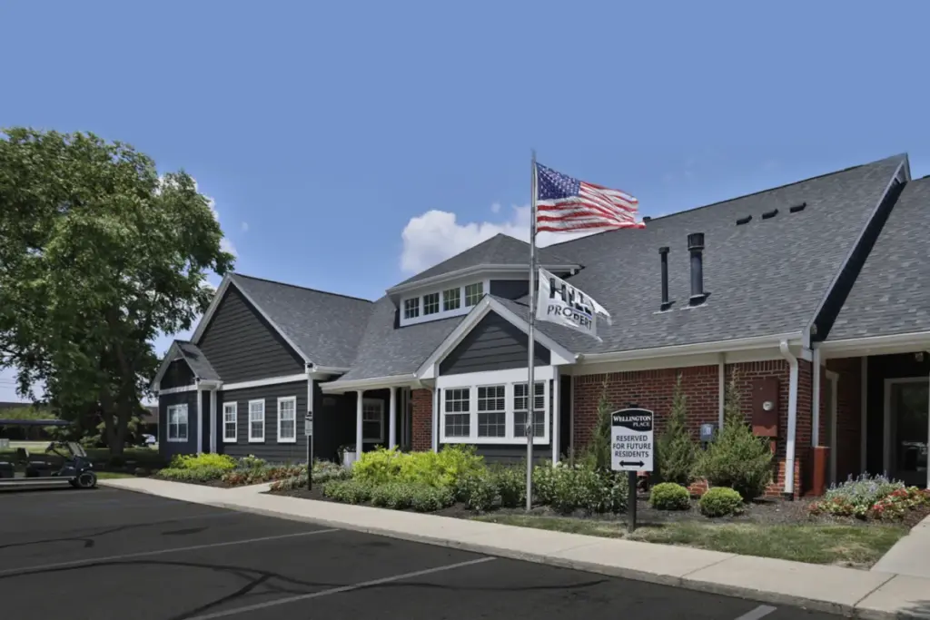 Clubhouse at Wellington Place Apartments featuring modern furnishings, a kitchenette, and stylish finishes, ideal for social gatherings and resident events.