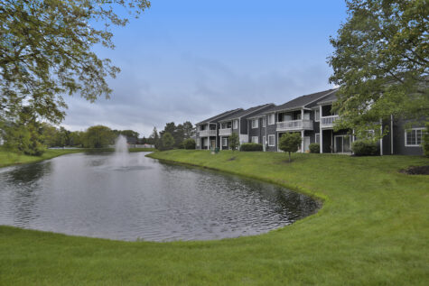 Scenic pond view at Wellington Place Apartments featuring calm water, surrounding greenery, and peaceful outdoor space within the community.