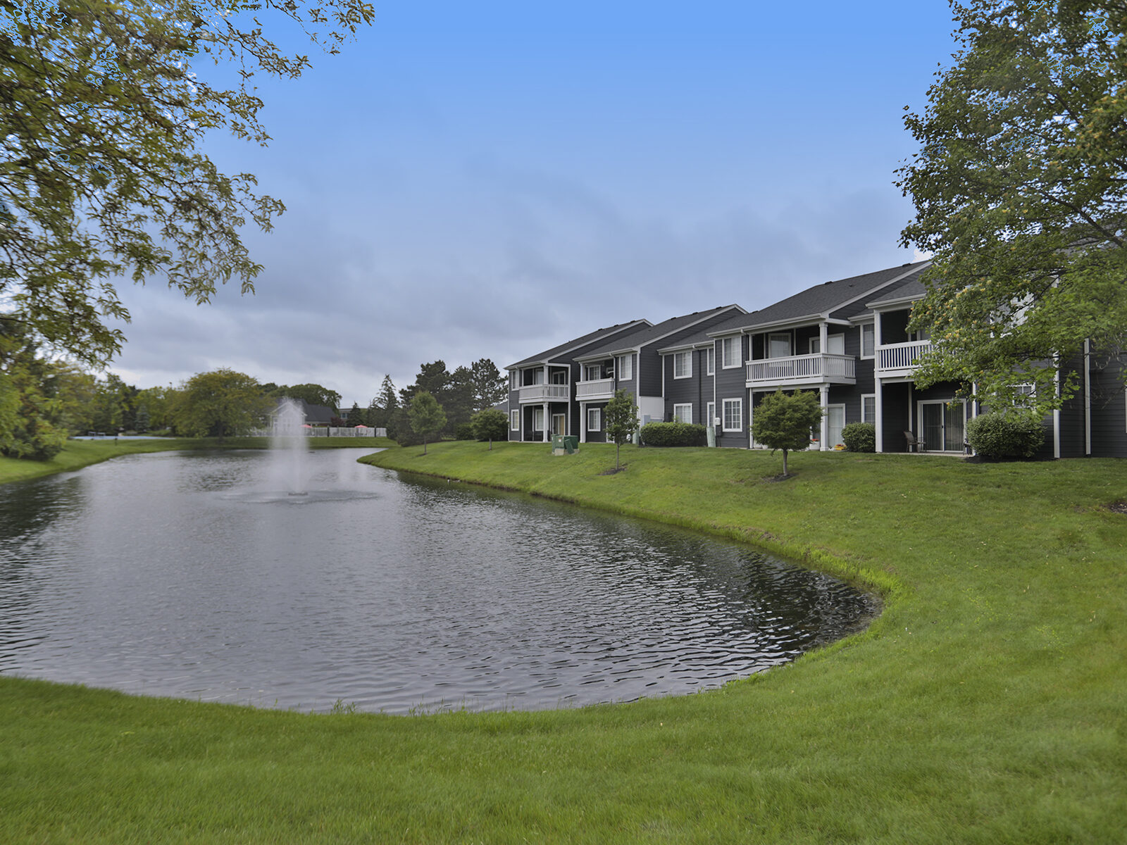 Wellington Place apartments near landscaping and a water feature.