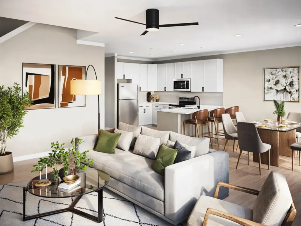 Open-concept living space at Relay 129 in Liberty Township featuring quartz countertops, stainless steel appliances, and two-tone cabinetry.