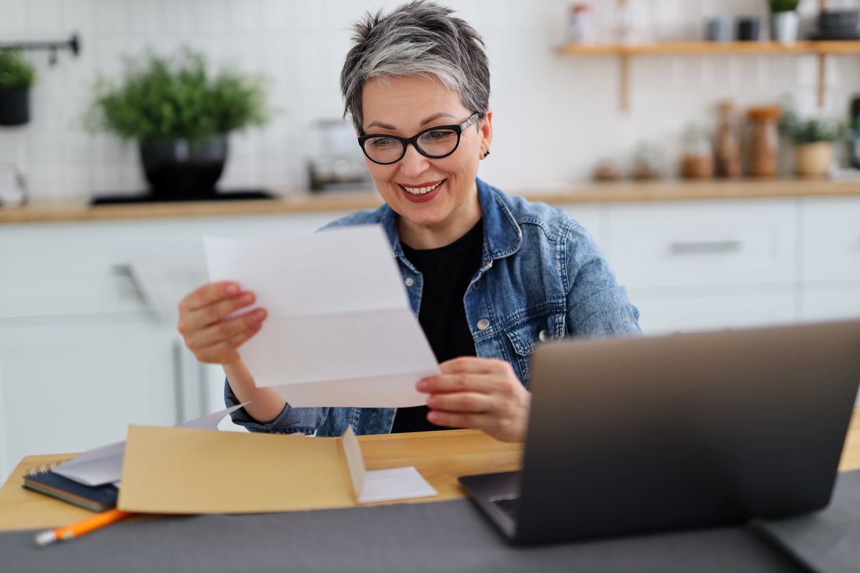 A woman reviewing her apartment lease smiling