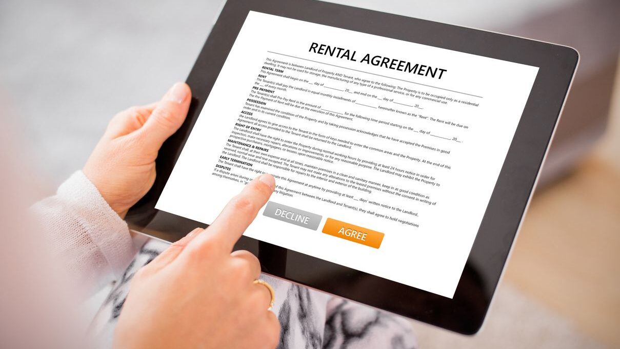 A resident signing their rental agreement on a tablet