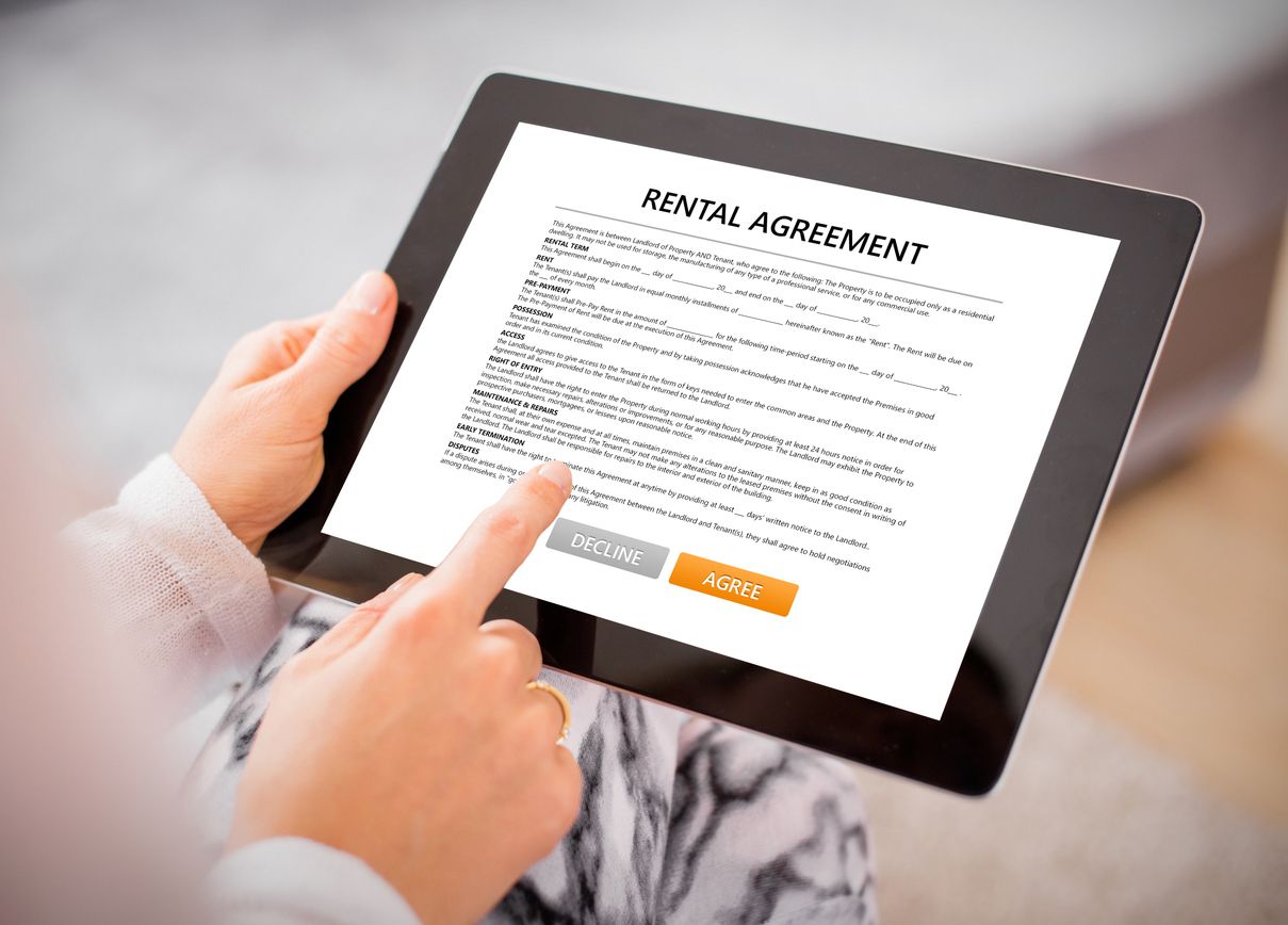 A resident signing their rental agreement on a tablet