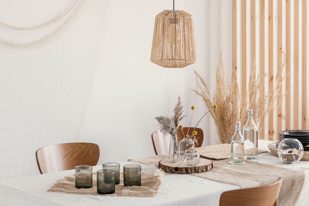 Rustic style kitchen and dining room with white walls and dark wooden furniture.