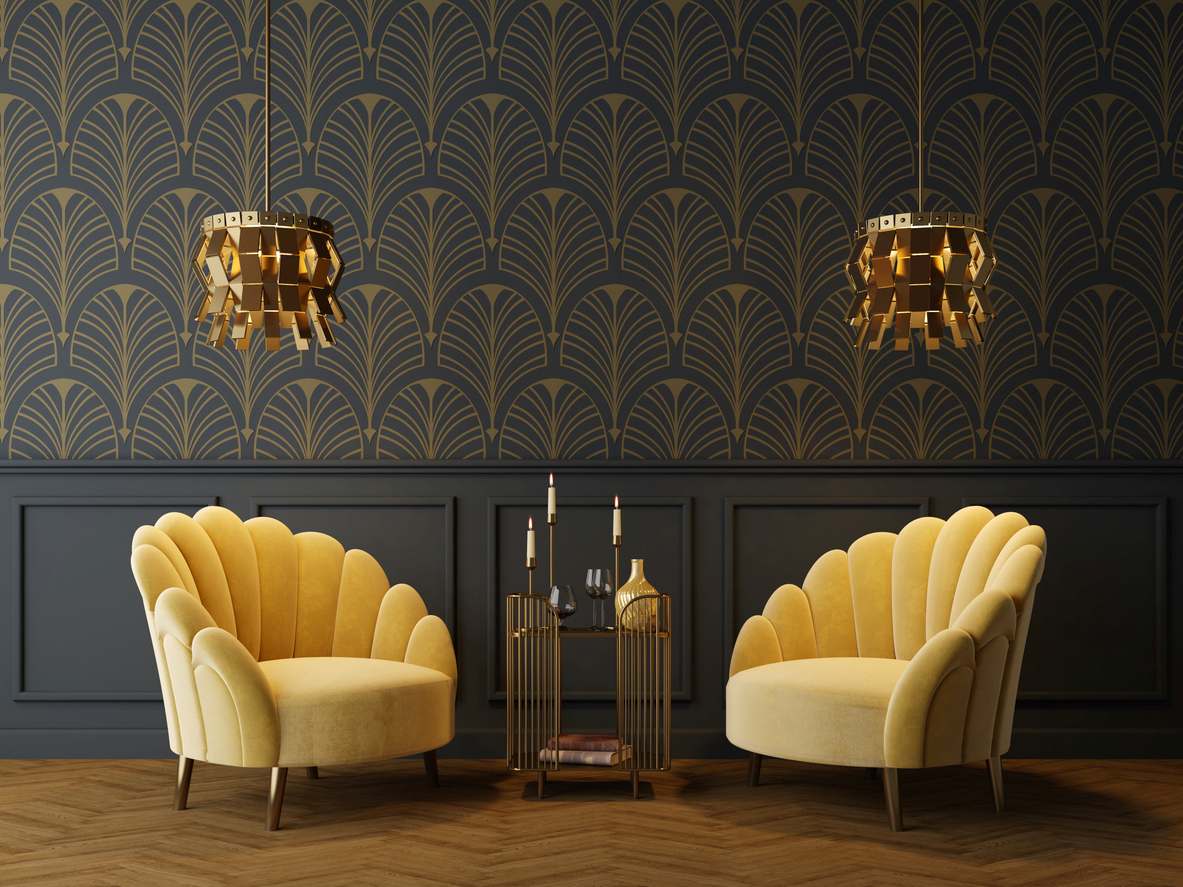 An Art Deco-inspired living room with yellow armchairs and lamps symmetrically settled in front of wallpaper.