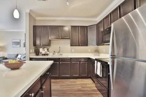 Stylish kitchen at Kendal on Taylorsville featuring a large island, designer lighting, and ample storage space.