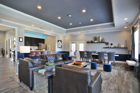 Modern clubhouse at Sterling Lakes showcasing stylish furnishings, high ceilings, and multipurpose areas for lounging, entertaining, or community events.