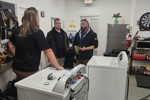 A demonstration with laundry machines during a workshop for the HILLS Tech Advancement Program.