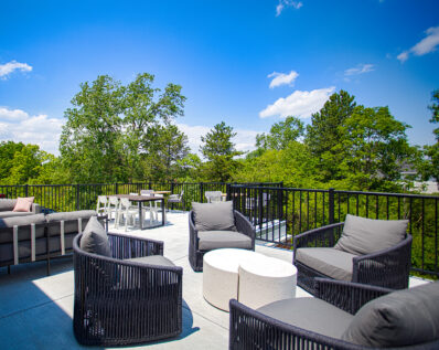 The rooftop retreat offers comfortable conversational seating surrounded by scenic greenery, creating a peaceful atmosphere to unwind, socialize, or work remotely outdoors.