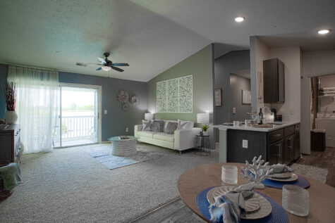 Open kitchen layout featuring quartz countertops, stainless steel appliances, and seamless flow into the living and dining areas.