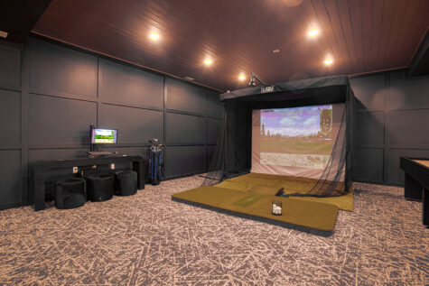 Indoor golf simulator at Vantage Anderson in Anderson, Ohio, offering residents a year-round virtual golf experience in a modern clubhouse by HILLS Properties.