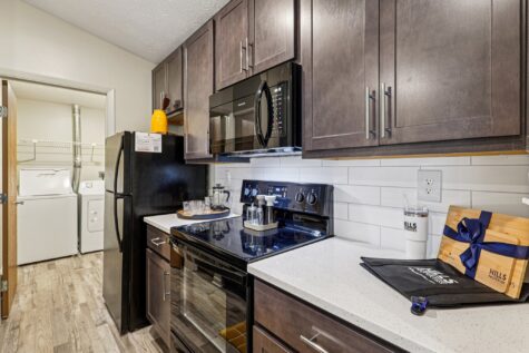 Updated kitchen featuring sleek cabinetry, quartz countertops, subway tile backsplash, and contemporary finishes throughout.