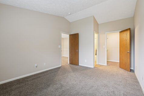 Primary bedroom with direct access to a walk-in closet and en-suite bathroom in the Hunter floor plan.