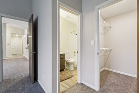 Hallway leading to the primary bathroom and walk-in closet within the Hunter floor plan at Fox Chase North Apartments.