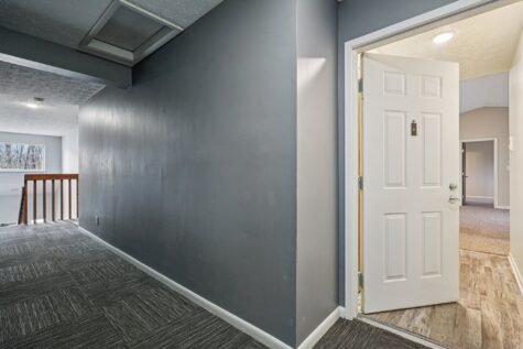 Interior hallway outside the Hunter floor plan showcasing updated common area finishes and apartment entry access.
