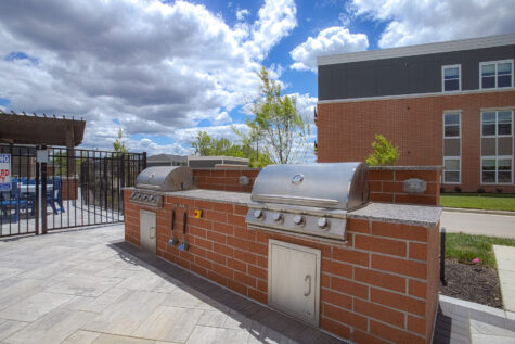 Built-in outdoor grilling station at Relay 129 Apartments and Townhomes featuring stainless steel grills, granite countertops, and dedicated spaces for outdoor dining and entertaining.