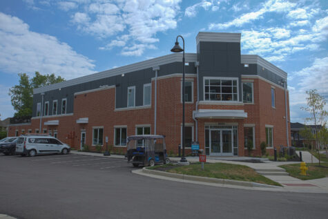 Exterior view of the clubhouse and leasing center at Relay 129 Apartments and Townhomes in Liberty Township, Ohio, featuring contemporary architecture, convenient parking, and a welcoming entrance.