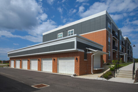 Detached garage buildings and apartment homes at Relay 129 Apartments and Townhomes in Liberty Township, Ohio, featuring contemporary architecture, private garages, and professionally maintained landscaping.