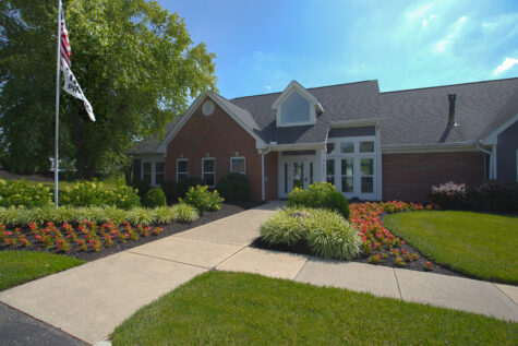 Exterior view of the clubhouse at Waterford Place Apartments in Loveland, Ohio, featuring traditional architecture, landscaped grounds, and a welcoming community entrance.
