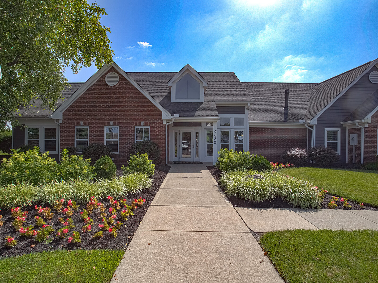 Exterior view of the clubhouse at Waterford Place Apartments in Loveland, Ohio, featuring traditional architecture, landscaped grounds, and a welcoming community entrance.